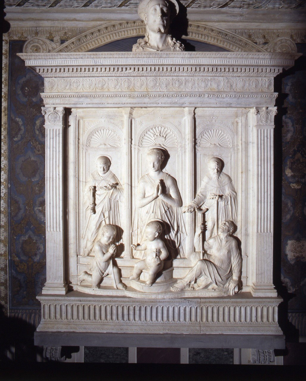 Madonna con Bambino, San Giovannino, San Remigio, San Leonardo (rilievo) by Mino
